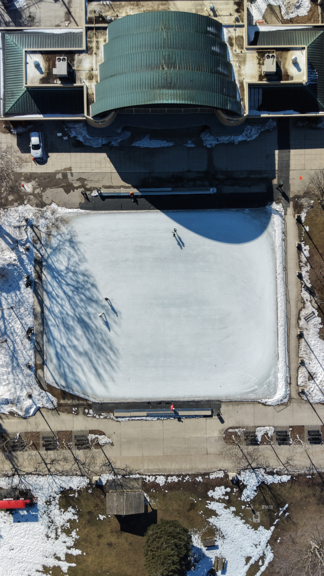 Aerial drone shot of people ice skating on the outdoor rink at Victoria Park
