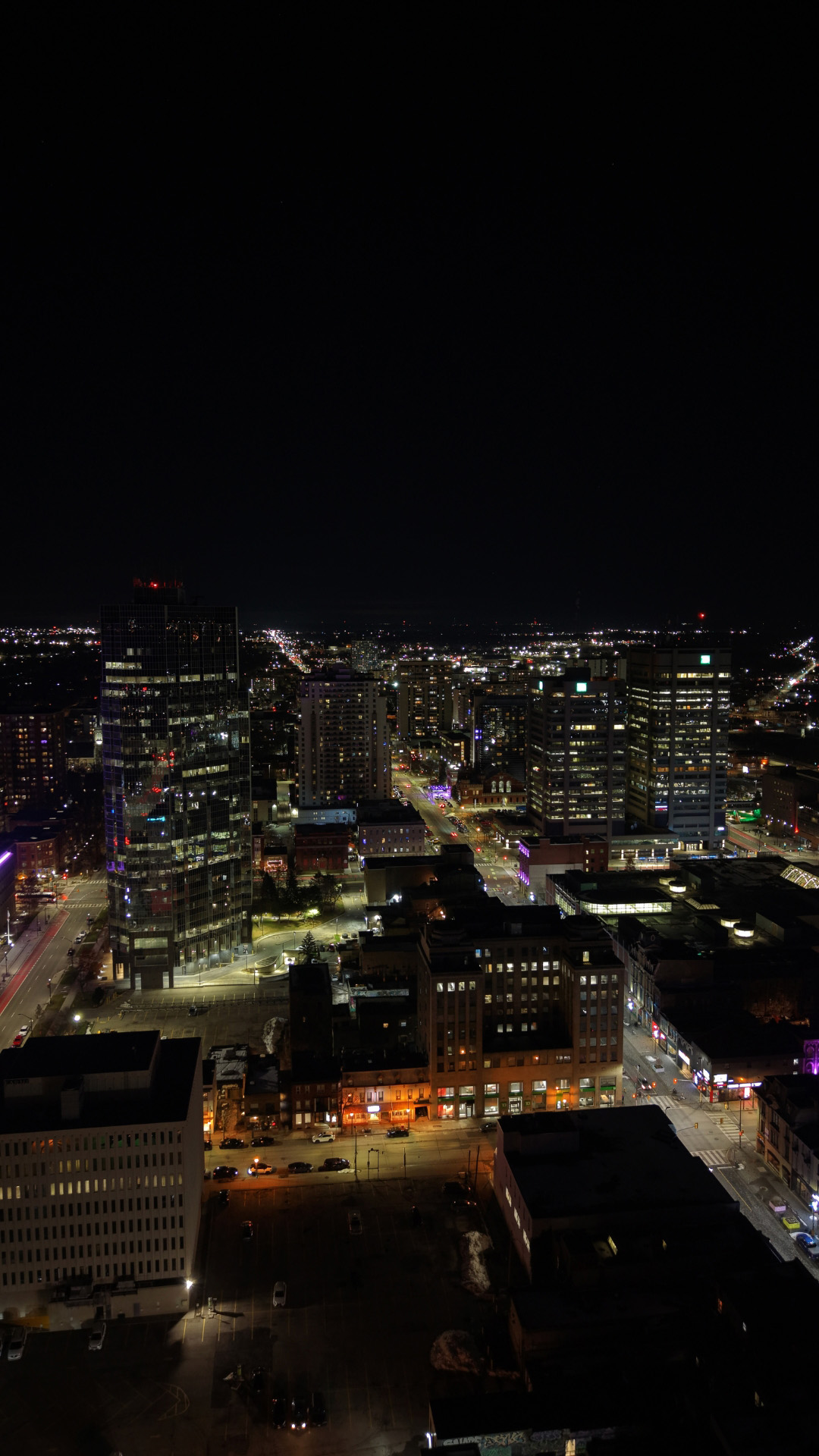 Stunning night-time drone shot showcasing the illuminated city skyline of London, Ontario
